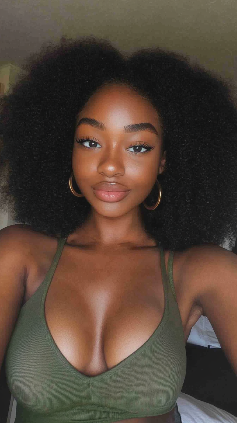 Afro beauty with warm skin and hazel eyes.