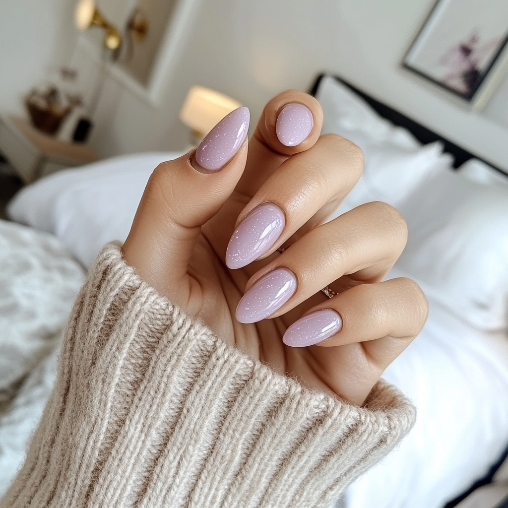 Candid photo of white woman showing shimmery lavender nails.