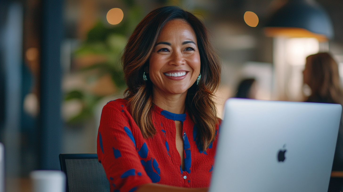 Smiling woman engaging in virtual meeting with soft lighting.