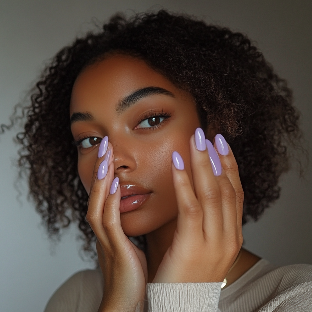 Candid photo of woman showing new lavender nails.