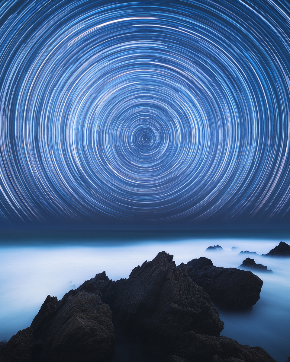 Star trails over sea rocks